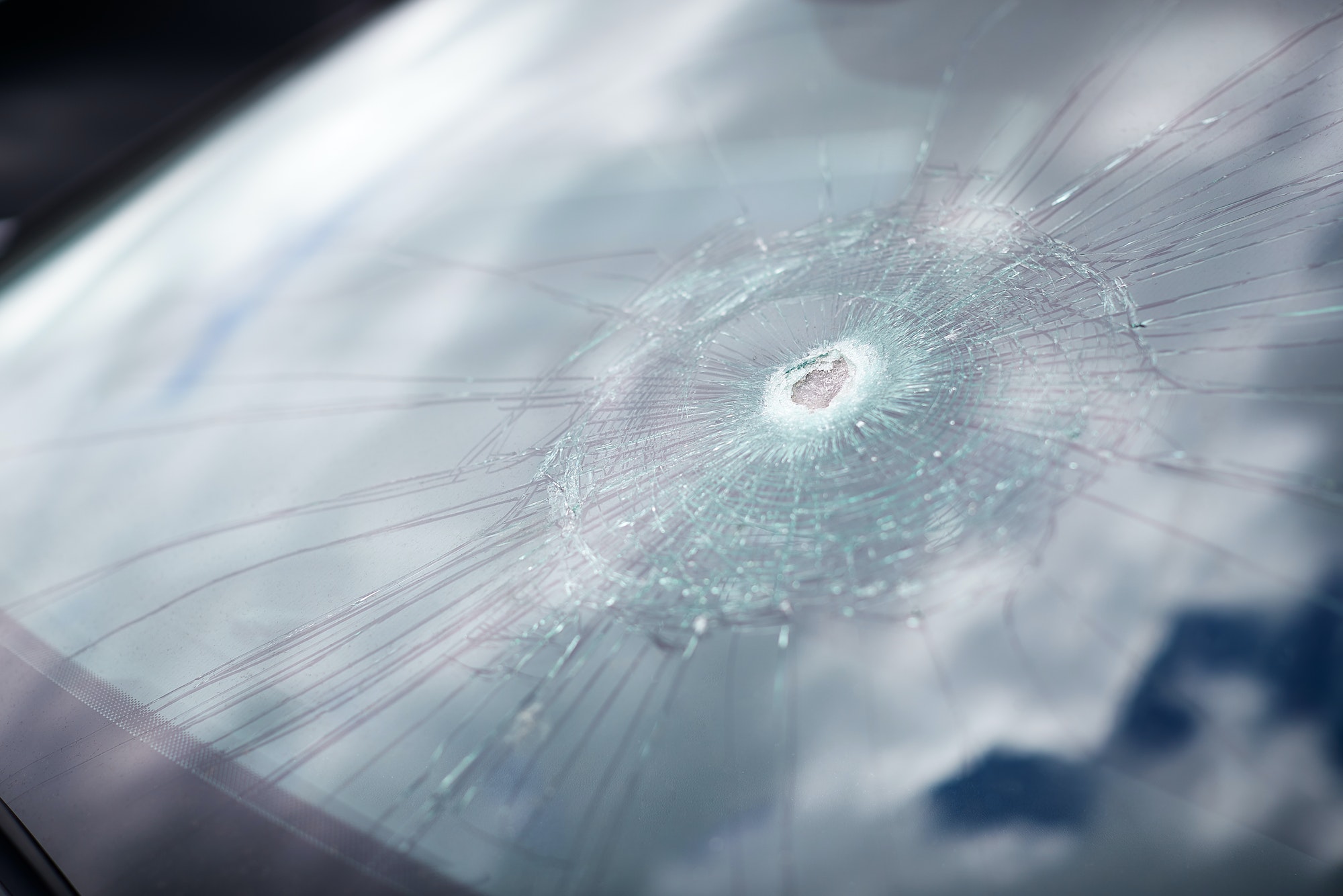 Close-up detail of damage to a car windscreen
