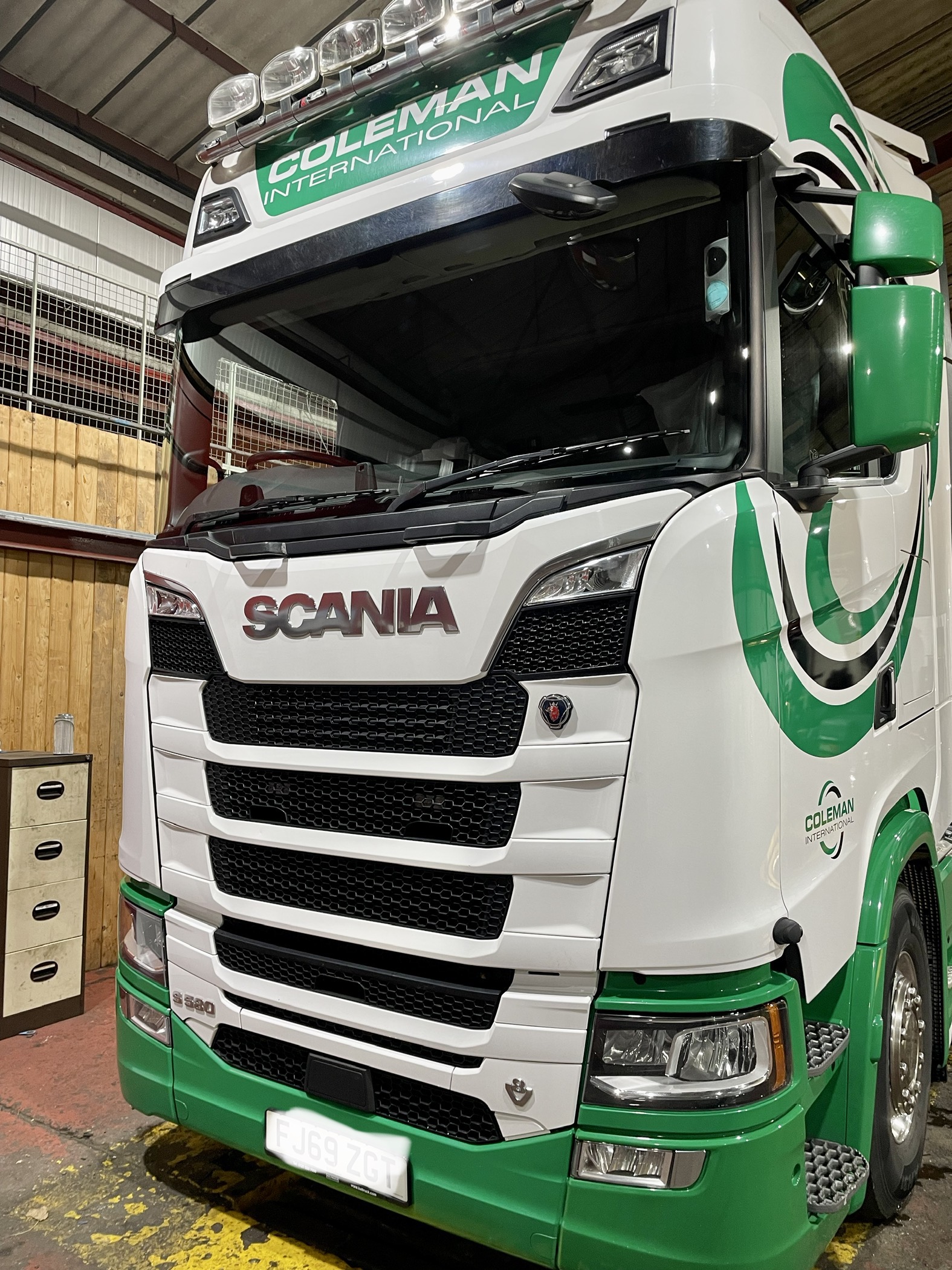 Windscreen work on a green and white Scania vehicle
